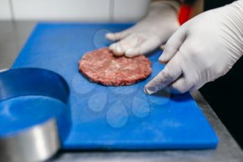 Chef hands in gloves prepares meat, burger cooking. Hamburger preparation process, fast food, bbq