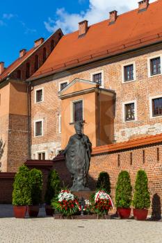 Monument to Pope John Paul II in Wawel cathedral castle, Krakow, Poland. European town with ancient architecture buildings, famous place for travel and tourism