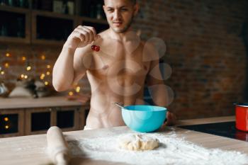 Man in underwear cooking dessert on the kitchen. Naked male person preparing breakfast at home, food preparation without clothes
