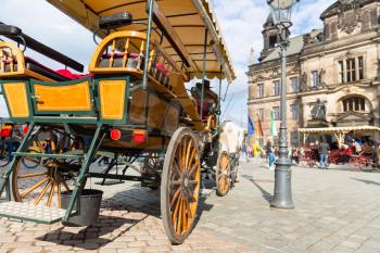 Excursion wagon with a horse in old European town. Summer tourism and travels, famous europe landmark, popular places and streets