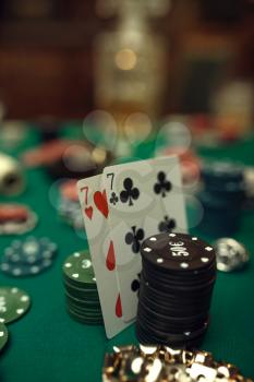 Poker concept, cards and chips on gaming table closeup, whiskey and cigar in casino, nobody. Games of chance. Gambling house business