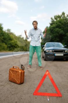 Emergency stop sign and petrol canister, car breakdown, man ran out of gas. Broken automobile or repairing of flat tyre on vehicle, trouble with punctured auto tire on highway