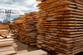 Stacks of boards on timber mill warehouse outdoor, nobody, lumber industry, carpentry. Wood processing on factory, forest sawing in lumberyard, sawmill