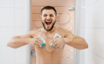 Screaming man removes chest hair, morning hygiene, waxing depilation. Male person resting in bathroom, skin and body treatment procedures