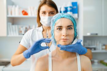 Cosmetician holds syringe with injection of botox at female patient face. Rejuvenation procedure in beautician salon. Doctor and woman, cosmetic surgery against wrinkles and aging
