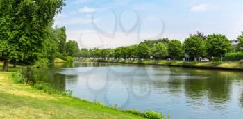 Park with lake in old European town. Summer tourism and travels, famous europe landmark, popular places for tourists
