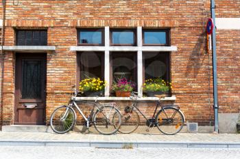 Bicycles at ancient building facade, old provincial European town. Summer tourism and travels, famous europe landmark, popular places