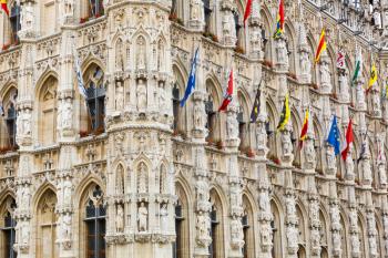 Ancient stone building facade with big windows, old Europe. European architecture, medieval town, famous places for tourism and travel