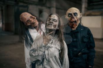 Three zombies in abandoned factory, scary place. Horror in city, creepy crawlies attack, doomsday apocalypse, bloody evil monsters