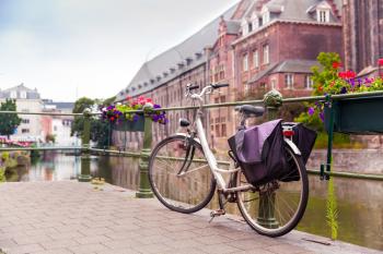 Bicycle on pier, river in old town, Europe. Ancient european city, famous place for travel and tourism