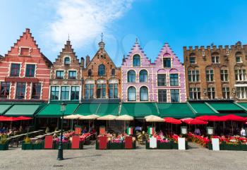 Cozy street cafe and old building facades in old European tourist town. Summer tourism and travels, famous europe landmark, popular places for travelling