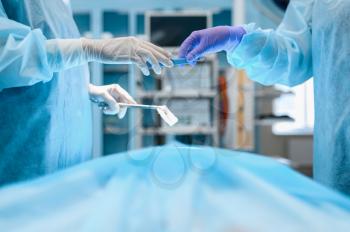 Female surgeon and assistant, surgery operation in action, operating room. Doctor in uniform, medical clinic worker, medicine and health, healthcare in hospital