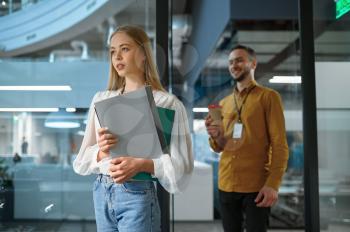 Male and female managers, meeting in IT office. Professional teamwork and planning, group brainstorming and corporate work, modern company interior on background