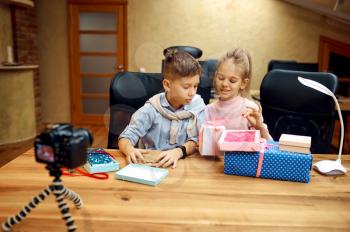 Children bloggers poses on camera, little bloggers. Kids blogging in home studio, social media for young audience, online internet broadcast