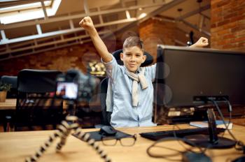 Happy boy recording vlog, little blogger. Kid blogging in home studio, social media for young audience, online internet broadcast