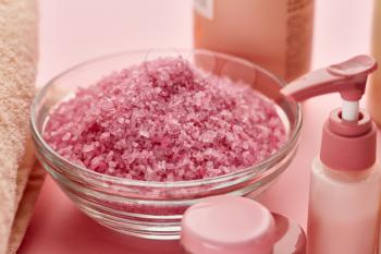 Skin care products and sea salt on pink background, nobody. Healthcare procedures concept, hygiene cosmetic, healthy lifestyle, spa and bath
