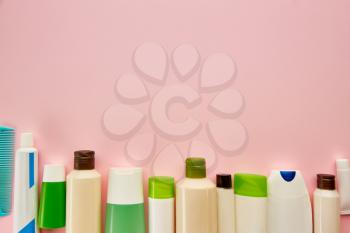 Skin care products in tubes, macro view, pink background, nobody. Morning healthcare procedures concept, hygiene tools, healthy lifestyle
