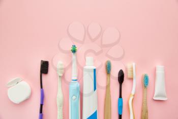 Oral care products, pink background, nobody. Morning healthcare procedures concept, toothcare, different toothbrushes and toothpaste, brush and cream in bottle