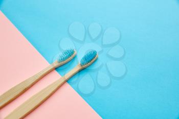 Oral care products concept, blue background, nobody. Morning healthcare procedures concept, toothcare, two toothbrushes
