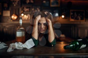 Depressed drunk woman in bar, stress relief. One female person in pub, human emotions, leisure activities, depression