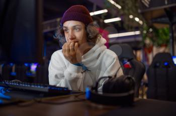 Young gamer staring at the monitor, game club. Virtual entertainment, e-sport tournament, cybersport lifestyle. Male person leisures in internet cafe