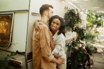 Love couple embraces in rv, camping in a trailer. Man and woman travels on van, romantic vacations on motorhome, campers leisures in camping-car