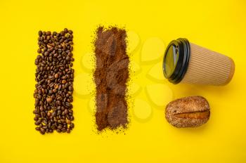 Coffee bean decoration and cup isolated on yellow background, top view. Organic vegetarian food, grocery assortment, natural eco products, healthy lifestyle concept