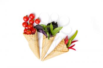 Fresh vegetables in waffle cones, isolated on white background. Organic vegetarian food, grocery assortment, natural products, healthy lifestyle concept