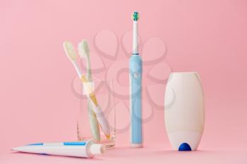 Oral care products, toothbrush, toothpaste and dental floss, pink background, nobody. Morning healthcare procedures concept
