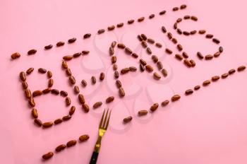 Beans word isolated on pink background, top view. Organic vegetarian food, grocery assortment, natural eco products, healthy lifestyle concept