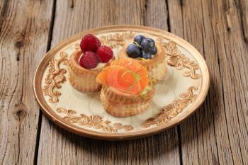 Custard filled puff pastry shells topped with fresh fruit