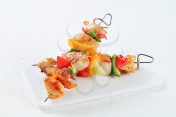 Chicken skewers on a cutting board