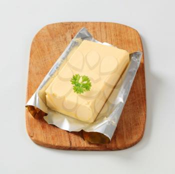 Block of fresh butter on a cutting board