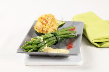 Vegetarian meal - Avocado with scrambled eggs and green beans