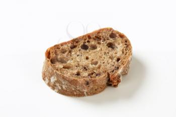 Slice of brown bread on white background