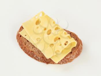 Slice of brown bread and Swiss cheese
