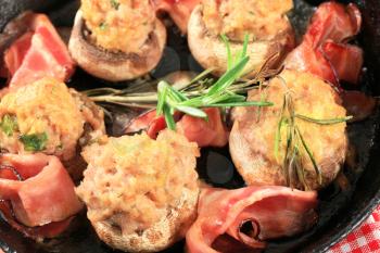 Mushrooms stuffed with ground meat and slices of Parma ham