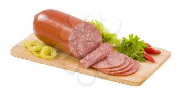Sausage of soft salami on a cutting board