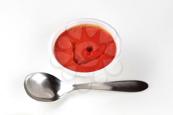 Bowl of tomato paste and spoon 