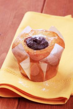 Chocolate filled muffin on a yellow napkin