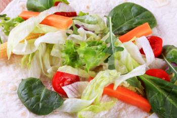 Fresh vegetable salad spread on  a tortilla