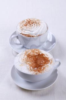 Cups of cappuccino and Vienna coffee