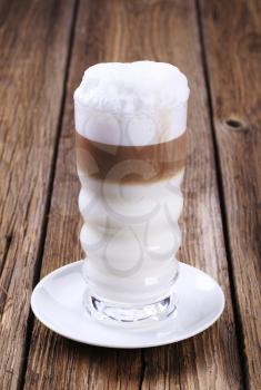 Glass of Latte macchiato with milk foam 