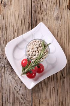 Raw beans, tomatoes and rosemary - still life