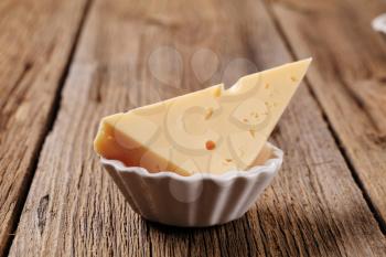 Piece of edam cheese in a small bowl