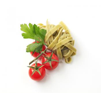 Spinach ribbon pasta and fresh tomatoes - studio