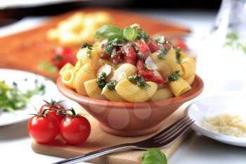 Macaroni with capers, crushed tomatoes and pesto