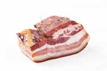 Closeup of cured bacon on white background