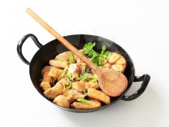 Pieces of marinated chicken breast with garlic and onion in a pan