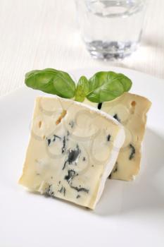 Wedges of blue cheese with white rind